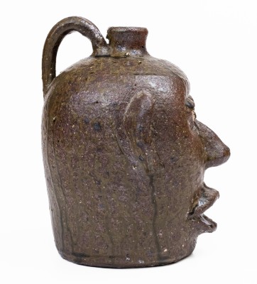 Alkaline-Glazed Stoneware Face Jug with Open Mouth Lacking Teeth, Signed 