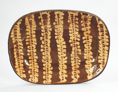 Outstanding Large-Sized Slip-Decorated Redware Loaf Dish, English origin, 19th century