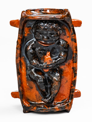 Rare and Important Figural Redware Baby-in-Cradle Bank, probably Pennsylvania
