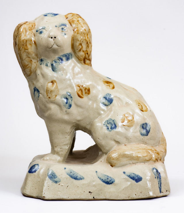 Scarce Stoneware Spaniel on Base with Two-Color Slip Decoration, attributed to the Donaghho Pottery, Parkersburg WV, circa 1890.