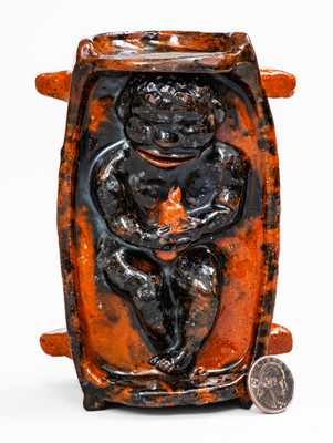 Rare and Important Figural Redware Baby-in-Cradle Bank, probably Pennsylvania