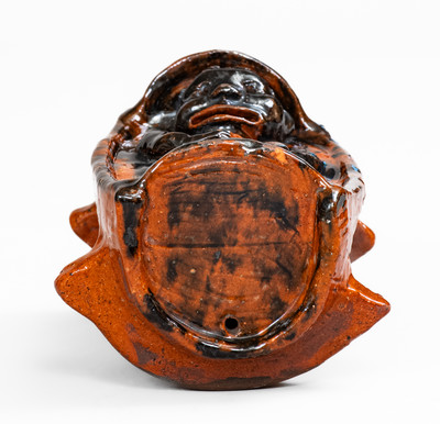 Rare and Important Figural Redware Baby-in-Cradle Bank, probably Pennsylvania