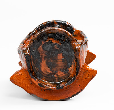 Rare and Important Figural Redware Baby-in-Cradle Bank, probably Pennsylvania