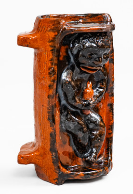 Rare and Important Figural Redware Baby-in-Cradle Bank, probably Pennsylvania