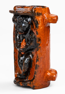 Rare and Important Figural Redware Baby-in-Cradle Bank, probably Pennsylvania