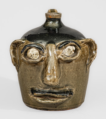 Exceedingly Rare and Important Early-Period Lanier and Arie Meaders Face Jug w/ Rock Eyes and Black Slip