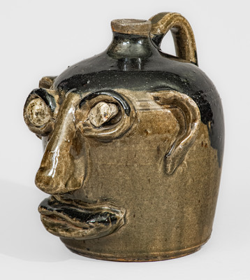 Exceedingly Rare and Important Early-Period Lanier and Arie Meaders Face Jug w/ Rock Eyes and Black Slip