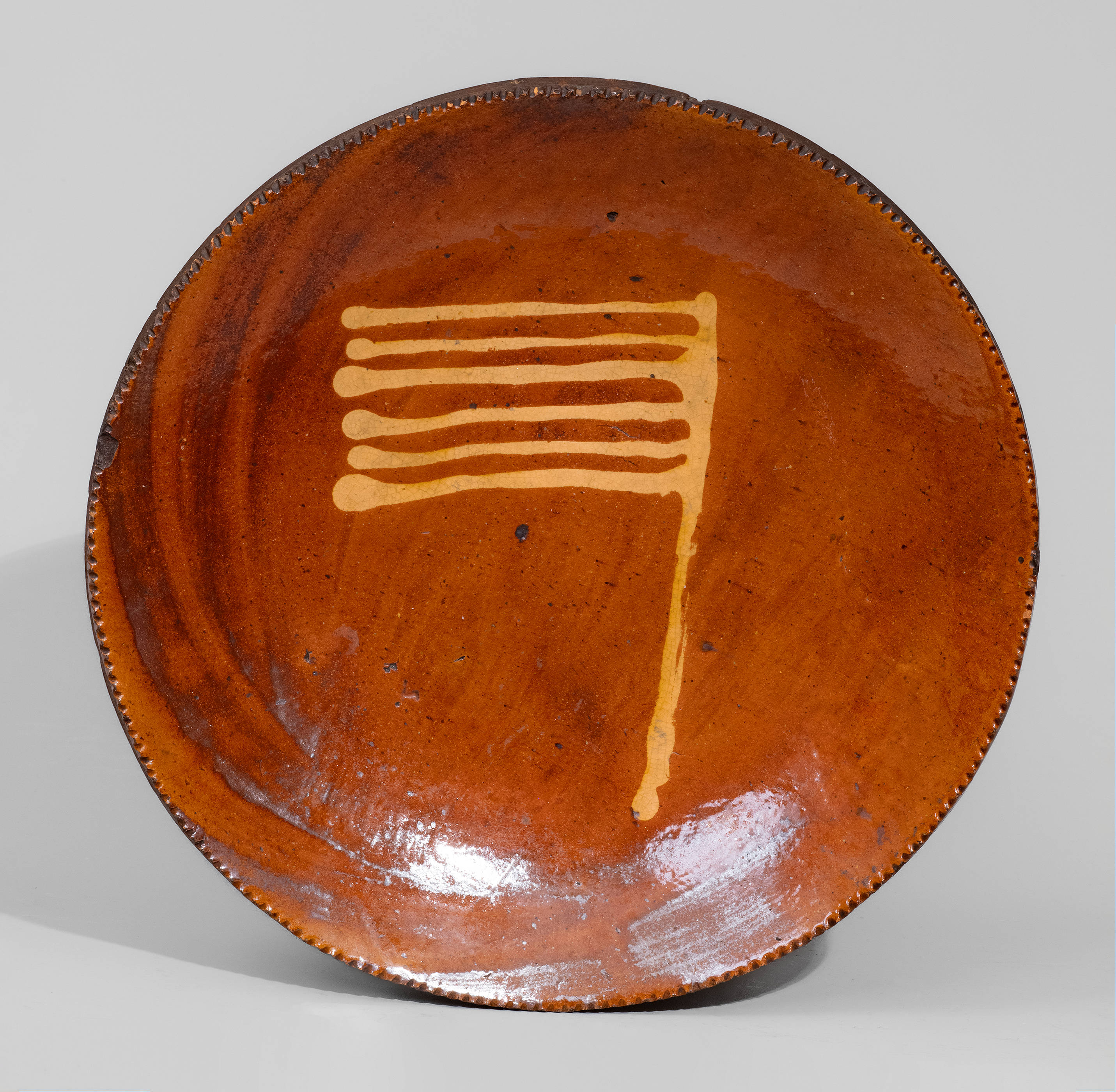 Rare Pennsylvania Redware Plate w/ Yellow-Slip Flag Motif, c1850